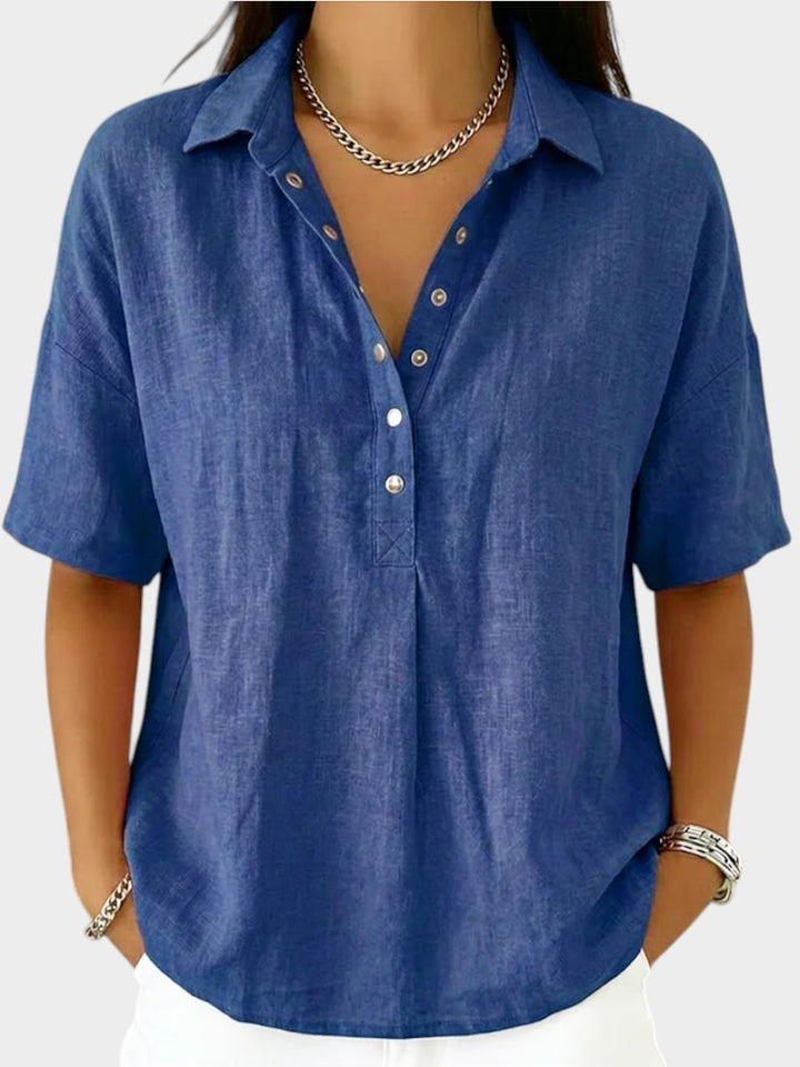 Victoria Boutique Adèle blue cotton blend blouse with collar, V-neck, and front button detail on a model