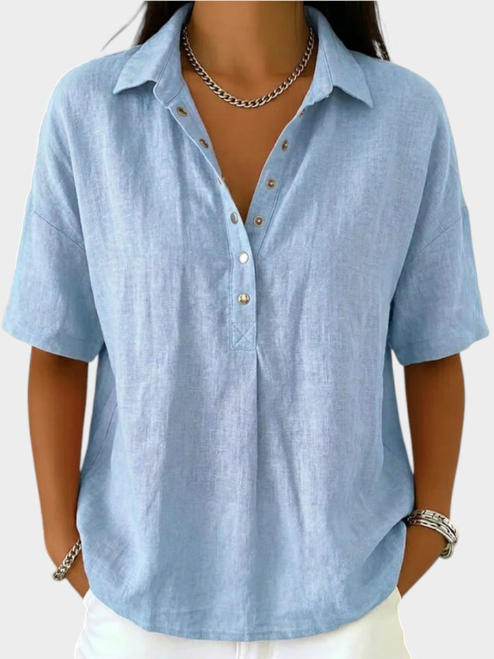 Victoria Boutique Adèle light blue cotton blend blouse with a collar, V-neck, and front button details.