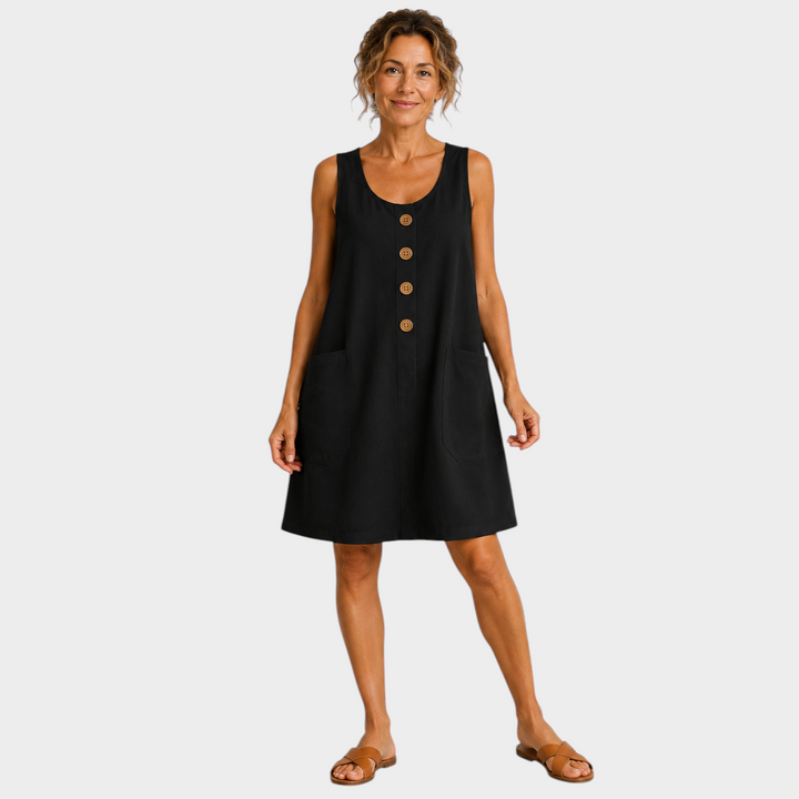 Victoria Boutique black cotton linen summer dress with U-neckline, decorative buttons, and pockets on a woman