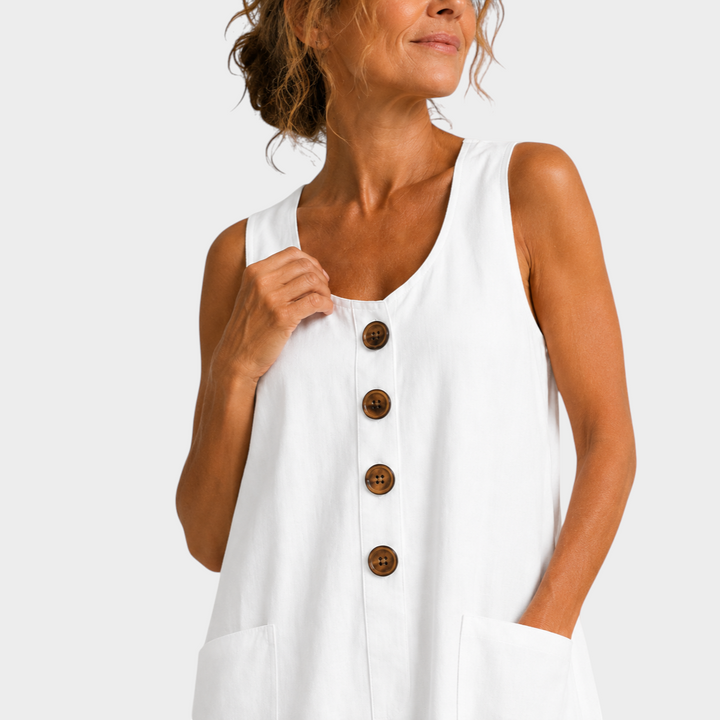 Victoria Boutique white cotton linen summer dress with U-neckline, decorative buttons, and side pockets on a model